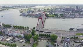 Inscription on video. Rotterdam, Netherlands. Williamsburg Suspension Bridge over the Nieuwe Maas River. Flames with dark fire, Aerial View, Point of interest