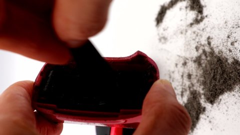 A person cleaning an electric shaver
