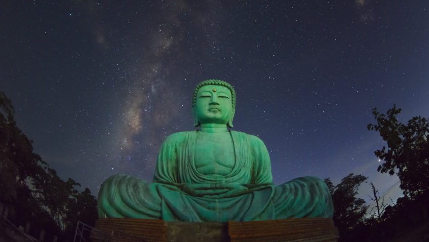 4K time-lapse video motion, Daibutsu or 'Giant Buddha' is a Japanese term often used informally for a large statue of Buddha, Giant Buddha with milky way moving in sky at night, Mae Tha Lampang. Royalty-Free Stock Footage #1086583517