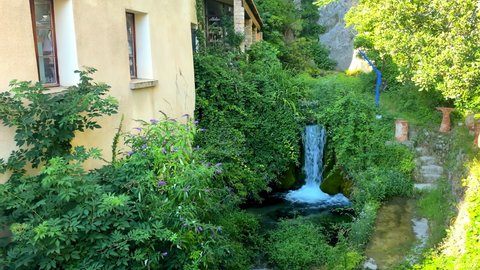 Moustiers-Sainte-Marie, France - August 2021 : Waterfall of the Riou river in the old village of Moustiers Sainte Marie