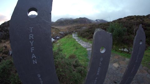 WALES, UK - 2022: A man hiking into the Welsh mountains of Snowdonia to Tryfan and Glyderau