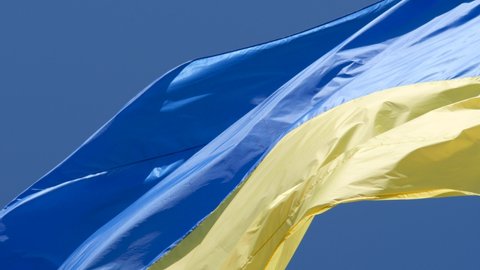 Highly detailed fabric texture flag of Ukraine. Slow motion of Ukraine flag waving background sky blue and yellow national color Ukrainian yellow-blue. Ukraine flag wind waving national symbol country