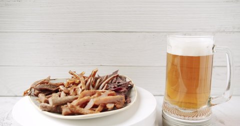 Craft Beer into the large glass. Beer Mug. On a white background. Half a liter, close up. Rotation 360 degrees. Glass full of beer with plate minced meat, and snacks. bbq meat set for beer snack. 