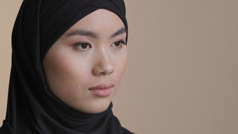 Female portrait islamic woman wear black hijab oriental girl in mourning widow muslim lady in head scarf looking into distance serious face perfect skin cosmetology thinking problems racism religion