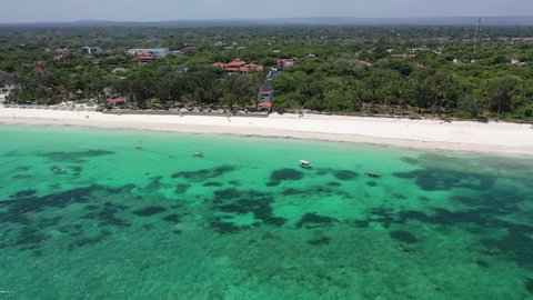  Diani beach landscape Kenyan coast African Sea drone aerial 4k waves blue indan ocean tropical mombasa turquoise white sand East Africa palms paradise view Wood boats on water