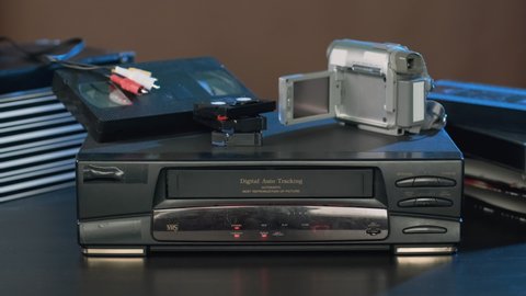 Man Ejecting Tape from VHS Video Player. Data Archiving, Videotape Cassette Recorder, Old Technology