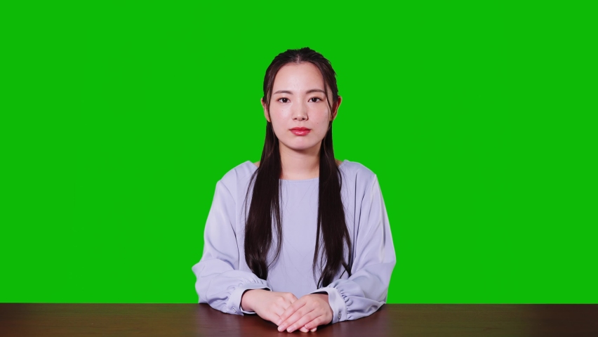 Young asian woman taking video calling. Green background for chroma key composition. Royalty-Free Stock Footage #1086599528