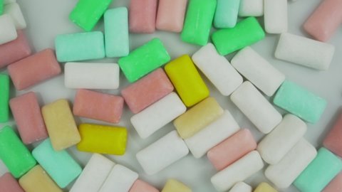 Group of variety bubble gums with fruit and mint filling fallen on table. Candy and confectionery industry conception.