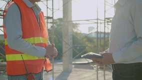 Shake hands Slow Motion video. Engineers and architects in safety uniforms holding hands in the building, Successful construction project, teamwork meeting.