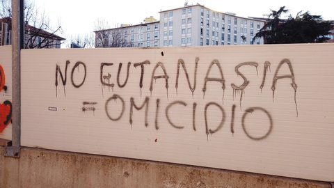 Europe, Italy , Milan  - Written on the wall No eutanasia = omicidio,     euthanasia = murder  in downtown of the city