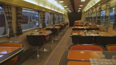 Nagoya.Japan-October 31.2019: Inside view of a restaurant wagon of a train. Railway museum in Nagoya Japan. Dining in long distance trains. Retro. Black and orange. Camera slowly moving right.