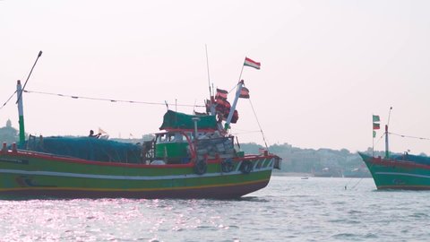 Boats in the Arabian sea at Okha Port in Gujarat, India. Fishing boats at the port with Indian flag on top of them. Small wooden fishing boats in the arabian sea.  Stockvideo
