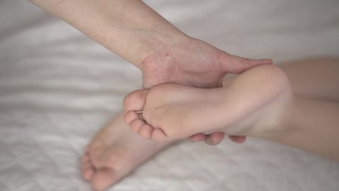 Children's therapeutic foot massage, body care concept