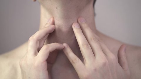 Sore throat and cough, man with pain in neck at home, health problems concept