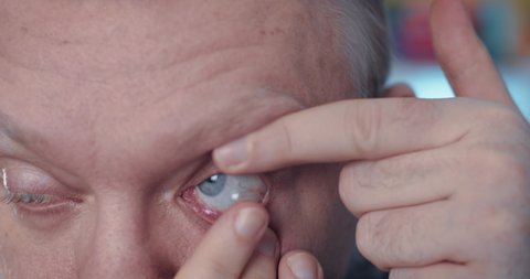Contact lens into eye. Man put on to eye of contact lens