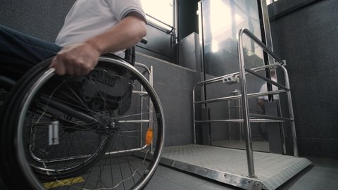 Special elevator for the person with a physical disabilities. A man in a wheelchair uses a special elevator
