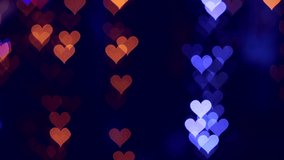 Video background of Valentines day. Heart bokeh background, blurred background. Abstract video blur of heart-shaped lights in the evening. 4K UHD Video.