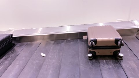 suitcases, bags travel along the moving belt at airport, passengers of flight receive their luggage, concept of baggage, hand luggage transportation, prohibited transport, damage and loss of things