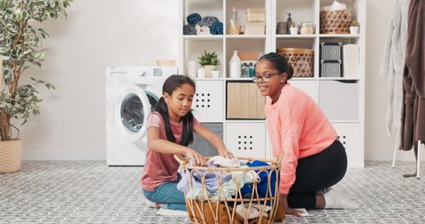 The daughter helps mother with household chores, the women sort laundry, fold clothes, prepare them for drying, they spend time together in the bathroom talking smiling