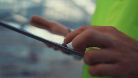 Closeup engineer hands holding tablet touching screen analyzing product information. Unknown professional manufacture specialist collect factory safety data in uniform. Digital manufacturing concept - Powered by Shutterstock - Get 15% off with code: PIKWIZARD15