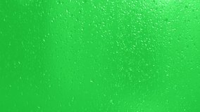 Rain Drops Falling down on green background. Drops trickling down on green glass background. Close up drops on glass or bottle. - Powered by Shutterstock - Get 15% off with code: PIKWIZARD15
