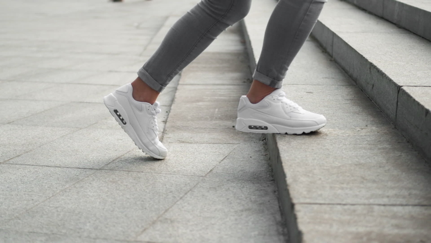 Stairs walk. Outdoor run. Sporty shoes. Closeup of training woman runner feet in athletic sneakers jogging climbing on street step. Royalty-Free Stock Footage #1086628535