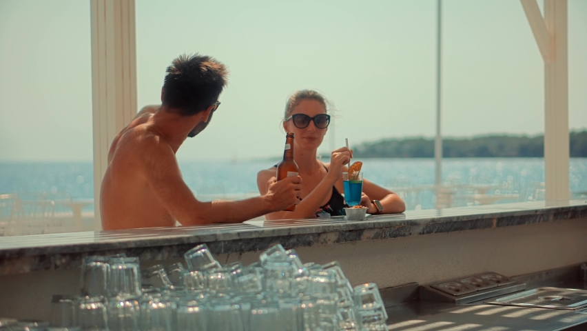 Couple Having Fun On Resort Bar. Holiday Vacation Summer Hotel. Drinking Beer And Cocktails On Bar. Summertime Relaxing Destination On Mediterranean Sea. Tropical Tourism Travel Leisure On Beachfront