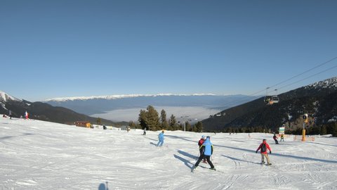 Bansko, Bulgaria - 15 Jan, 2022: People skiing, snowboarding in the ski resort Bansko, Bulgaria