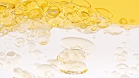 Slow Motion of Moving Yellow Golden Oil, Air Bubbles in Water Rising up on Light White Background. Transparent cosmetic gel fluid with bubbles. Macro Shot. - Powered by Shutterstock - Get 15% off with code: PIKWIZARD15