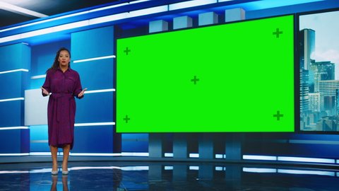 Talk Show TV Program: Beautiful Black Female Presenter Standing in Newsroom Studio, Uses Big Green Chroma Key Screen. News Achor, Host Talks About News, Weather. Playback Mock-up Cable Channel