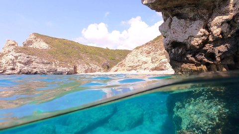 Underwater split video of paradise exotic island bay with crystal clear turquoise sea in Caribbean destination island