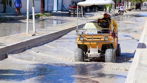 Holbox Mexico 21. December 2021 Golf cart buggy cars carts driving thru muddy street in village on Holbox Mexico.