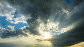 Sun rays shine through the dark clouds in the sky. Fast moving dark clouds on the blue sky. sky clouds and blue sky with sun.  - Powered by Shutterstock - Get 15% off with code: PIKWIZARD15