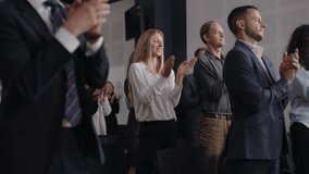 Group of people applauds to speech at business conference. Stage talk at summit meeting in crowded modern hall. Caucasian woman training at economic forum. Applause of executive female person indoors - Powered by Shutterstock - Get 15% off with code: PIKWIZARD15
