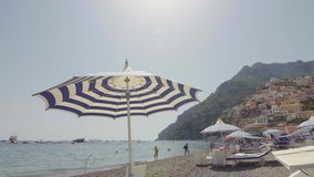 View of the Positano on the Amalfi Coast, Italy. Sunny day, tourists, coastline, beach, sea, boats, beautiful day, summer, Italian architecture, gimbal camera move - 4K Video Footage