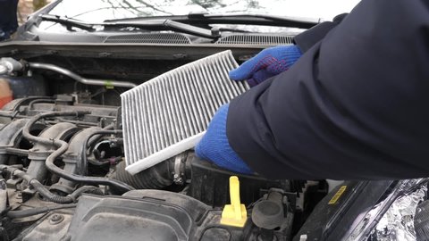 The wizard replaces the old car air filter. Car service. Ukraine. Lviv (08.02.22)