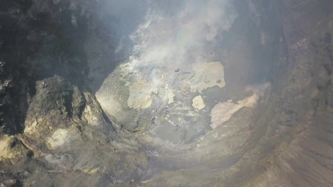 Active volcanic crater of Mount Bromo with smoke in slow motion - Bromo Tengger Semeru National Park, East Java, Indonesia