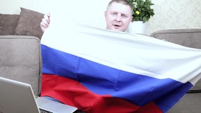 A fan of the Russian national team with a flag supports his team live