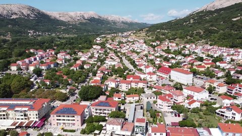 Aerial Drone View of Baška Beach, Krk Island, Croatia - Valley, Town, Mountains, Tourists and Blue Sea at a Summer Sunny Day