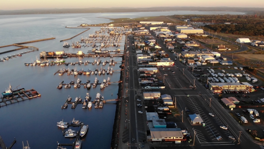 Aerial sunset view of Westport oregon, harbor with yacht and boat moored. Drone footage of Columbia river and coastline skyline port at Golden hours
