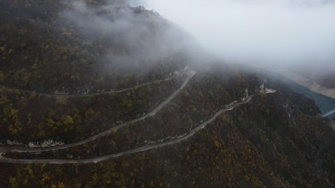 Aerial View of the mountain serpentine road in Kotor, Montenegro on a foggy day.