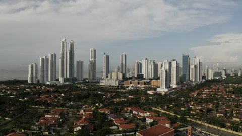 Aerial view of tall buildings in Panama City on a cloudy day, tracking wide shot, costa del este