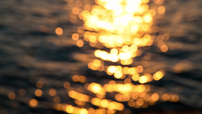 Blurred orange sea at sunset. Sun reflects and sparkles on waves with bokeh lights. Real time 4K resolution video. Abstract summer natural background. Copy space for your text. | Shutterstock HD Video #1086667100