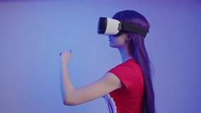 Long-haired European chick gestures using Virtual Reality Headset medium studio shot. High quality 4k footage