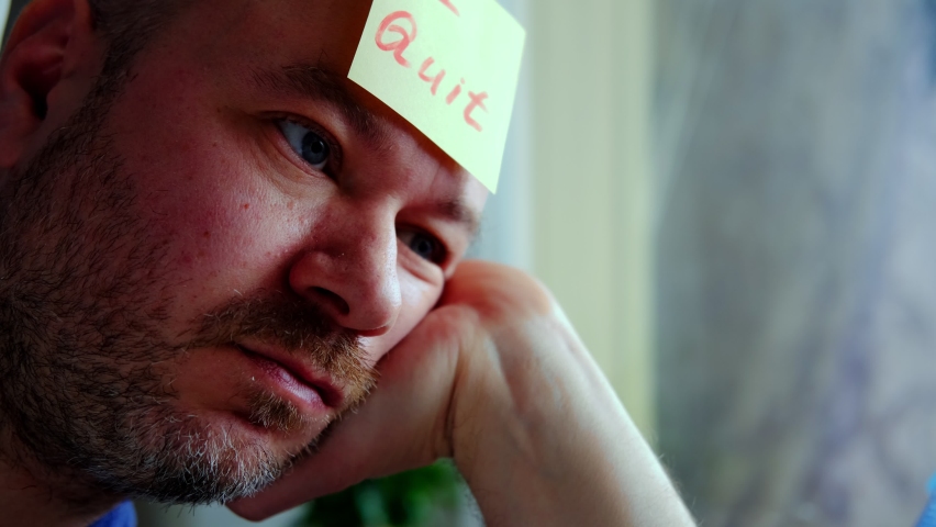 Sad middle aged man with a sticker I quit. Dismissal, unemployment, burnout concept.