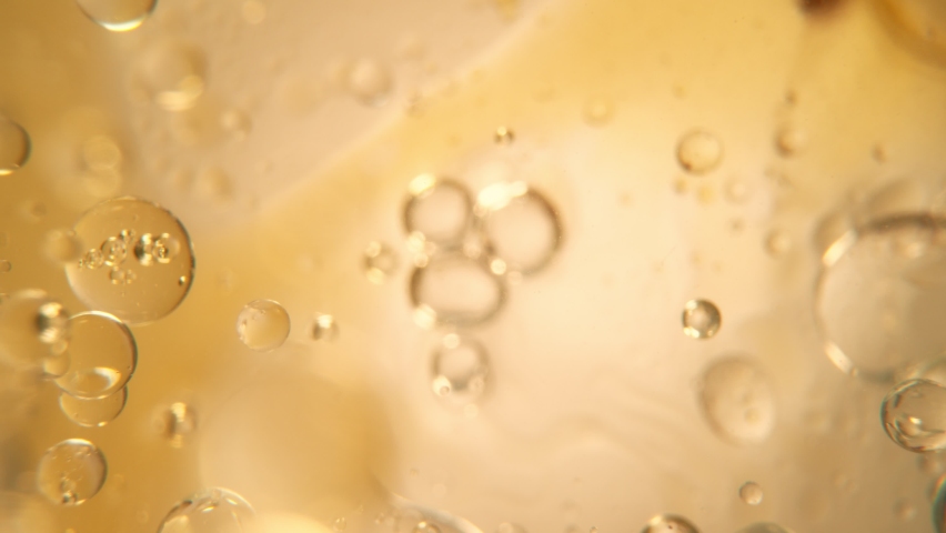 Super Slow Motion Shot of Oil Bubbles on Golden Background at 1000fps. Shoot on high speed cinema camera. Royalty-Free Stock Footage #1086672734