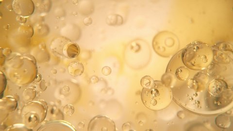 Super Slow Motion Shot of Oil Bubbles on Golden Background at 1000fps. Shoot on high speed cinema camera. - Βίντεο στοκ