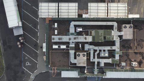 Cooling ventilation system with coolers and pipes on the roof of fast food restaurant. Climate Control on the roof - aerial drone panorama shot.