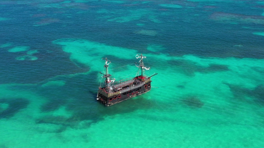 Pirate ship floating in caribbean sea. It is popular excursion for tourists. Dominican Republic. Aerial top view Royalty-Free Stock Footage #1086678233