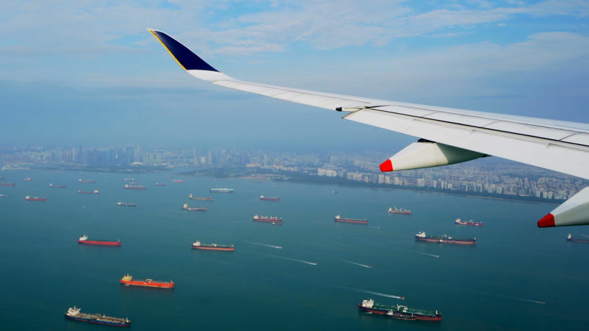 Large vessels. Many tankers. Ships on roadstead. View from plane. Singapore. Aerial view. Crossing of sea routes